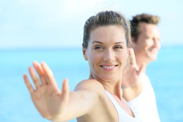 middle-aged woman working on her posture with yoga