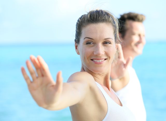 middle-aged woman working on her posture with yoga