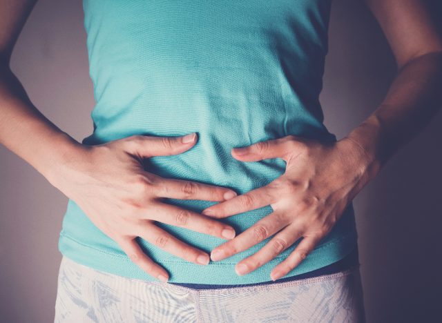 woman holding stomach, gut health