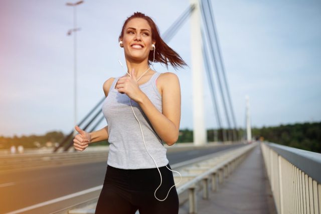 Woman jogs on bridge