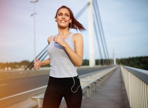 woman jogging on bridge