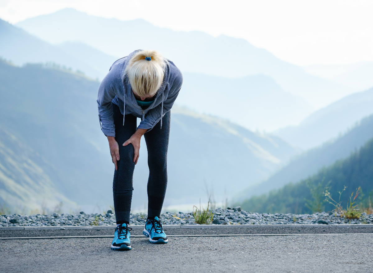 mature woman dealing with knee pain on walk, arthritis