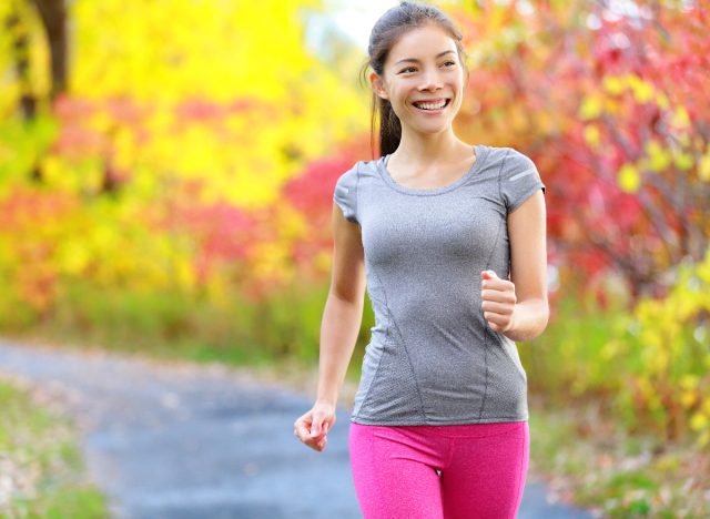 woman power walking outside to get rid of belly fat