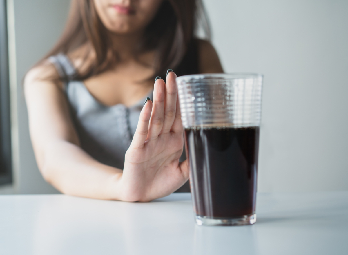 woman pushing soda away