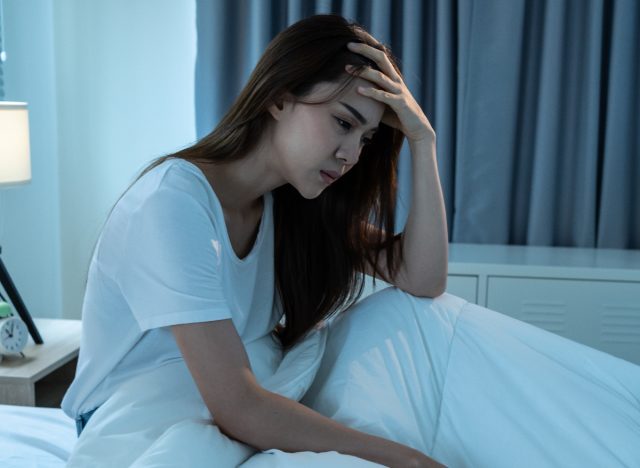 woman sad in bed, side effects of melatonin
