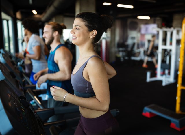 woman demonstrating treadmill cardio workout in gym to get rid of double chin fat