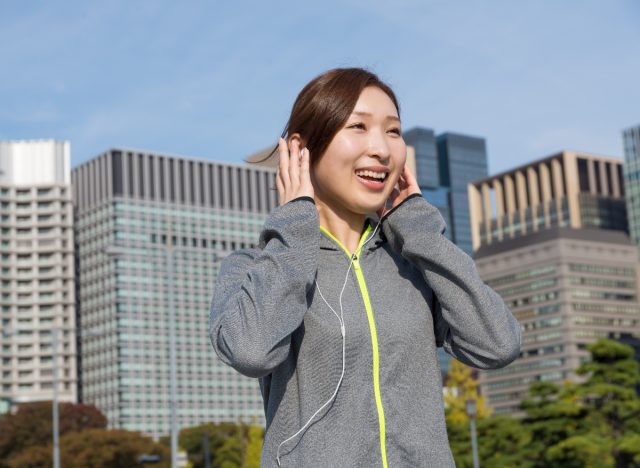 woman walk and talks outside on sunny day, exercise