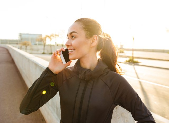 woman walking and talking on phone outside, burn calories while working