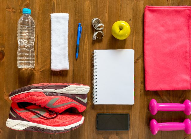 workout concept, sneakers, equipment, water bottle, towel, dumbbells