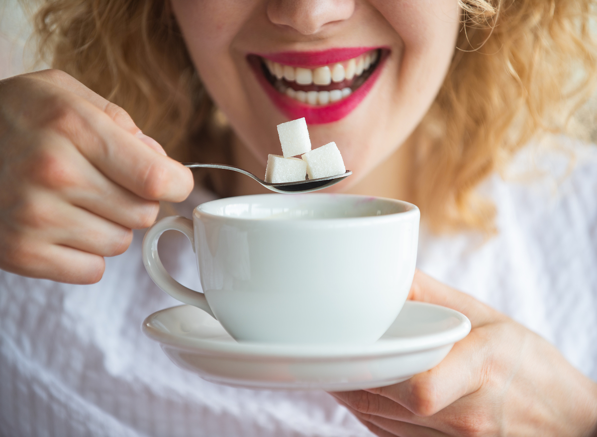 Putting sugar into coffee