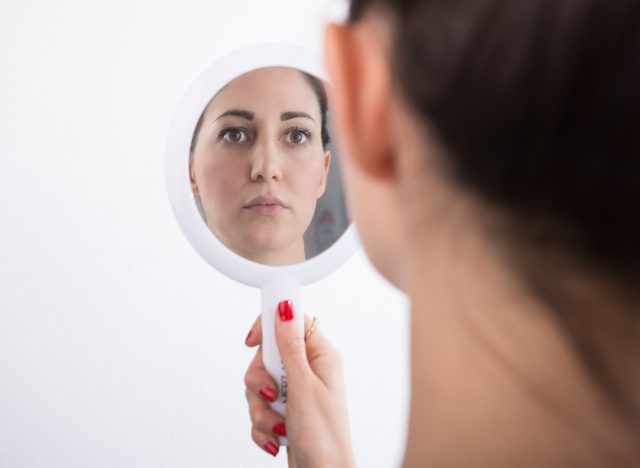 Woman looking in mirror