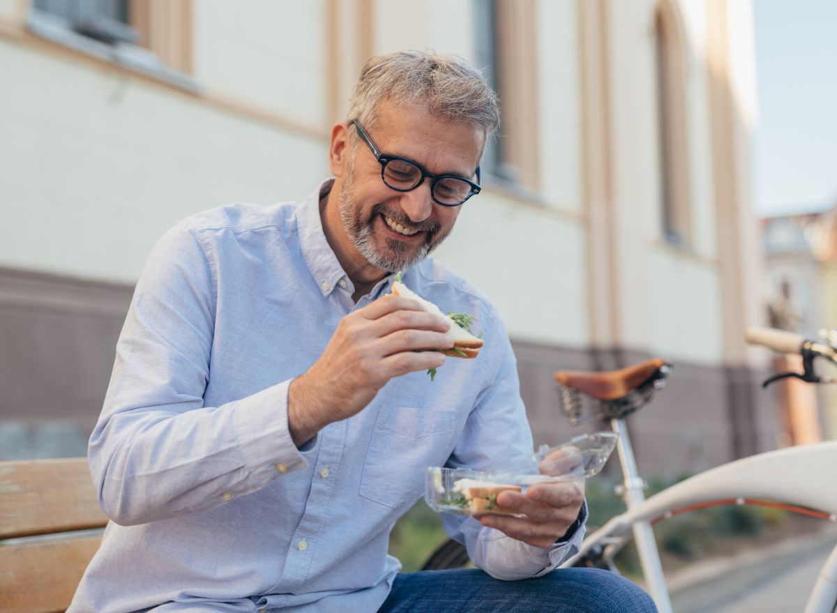 Middle aged man eating