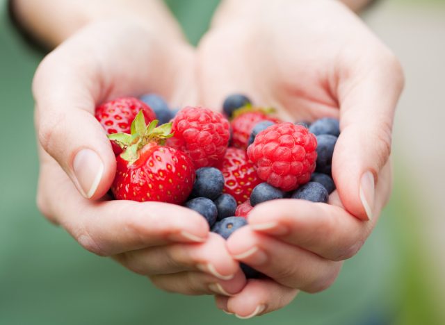 hand berries strawberries blueberries raspberries