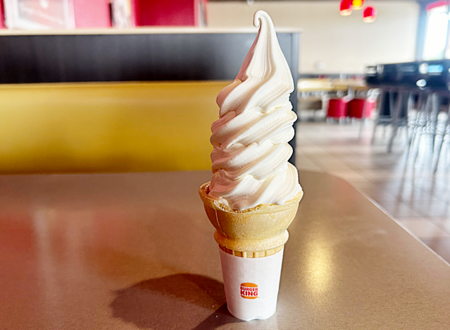 a vanilla soft serve cone on a table at burger king 