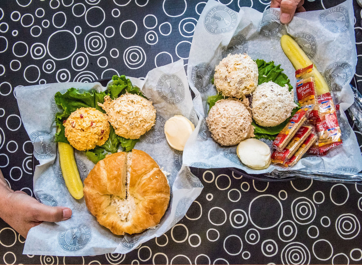 chicken salad chick's chicken salad sandwich with side of pickles, crackers, chicken salad, and lettuce