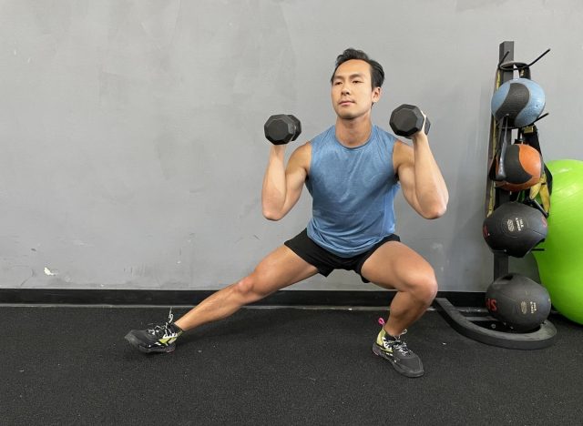 trainer doing cossack squat exercise to get rid of a flabby stomach