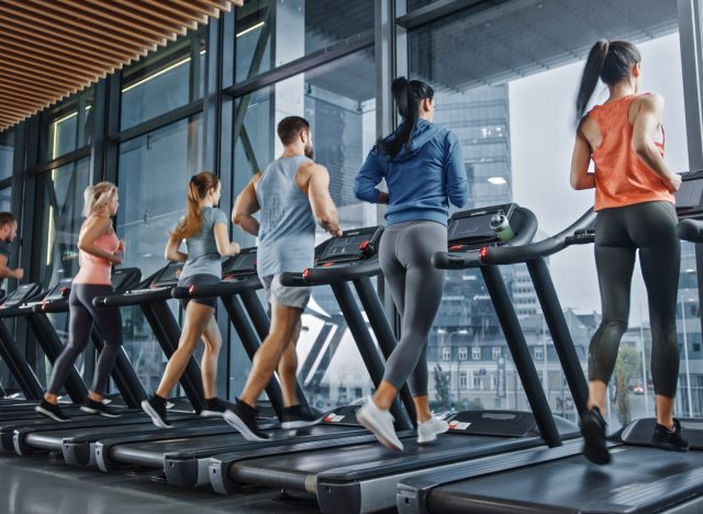 crowded gym people on treadmills