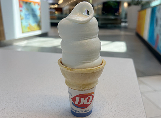 a soft serve vanilla cone on a table at dairy queen