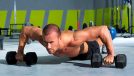 man performing dumbbell pushup as part of men's pot belly workout