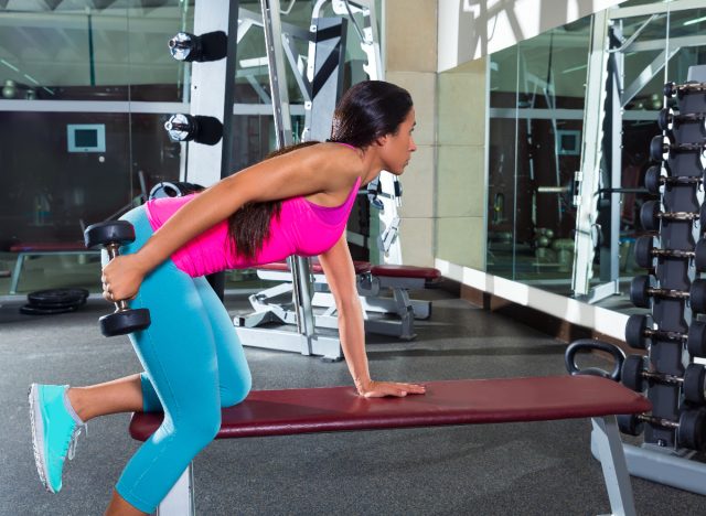 woman performing dumbbell tricep kickback