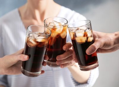 friends clinking soda glasses