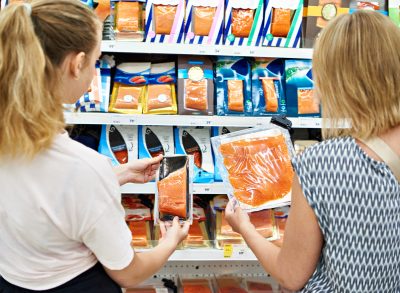 girls looking at packaged fish