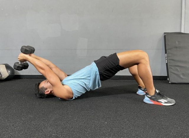 trainer performing glute bridge pullover exercise to get rid of a flabby stomach