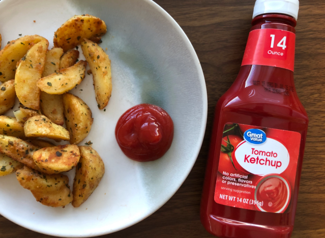 great value ketchup bottle next to fries and ketchup on plate. 