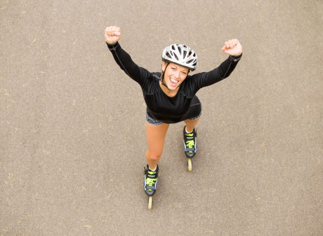 happy woman roller skating, demonstrating how to get your legs into shape