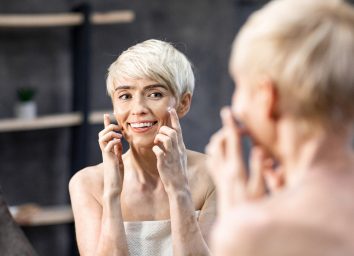 happy mature woman doing skincare routine to look 10 years younger