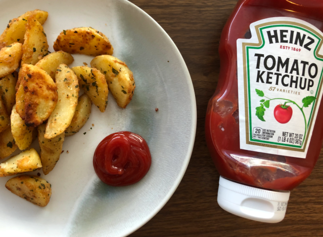 heinz ketchup bottle with ketchup and fries on a plate. 