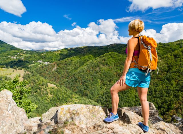 woman hiking outdoors, exercise to lose inches off your waist