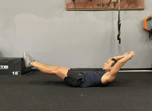 trainer demonstrating hollow body hold