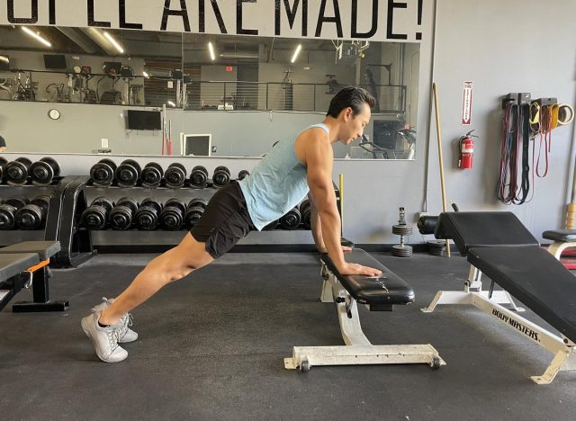 trainer demonstrating incline pushup, exercise to make body look 10 years younger