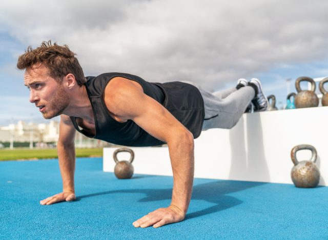 man doing decline pushup with legs raised, belly fat burner