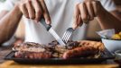 man cutting grilled meat