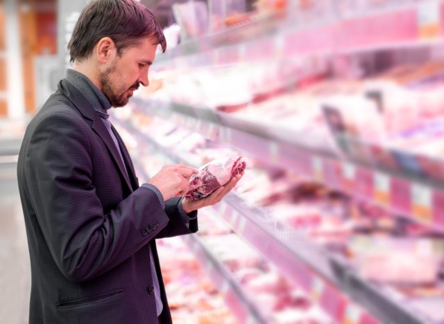 man reading meat label