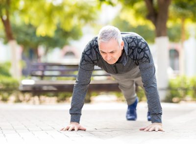 mature man performing pushups to reverse aging after 50
