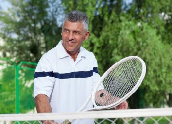 mature man playing tennis, exercises to prevent osteoporosis in your 50s