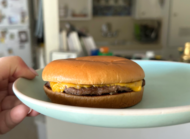 mcdonalds cheeseburger on a plate. 