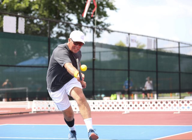 mature man warming up for pickleball game