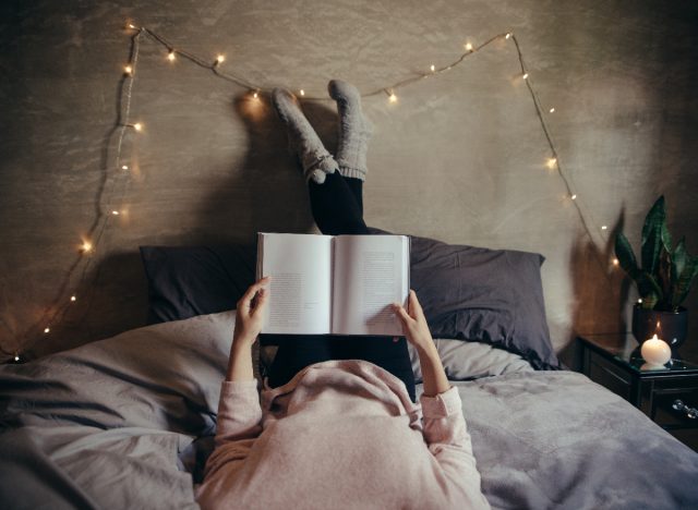 woman cozy reading in bed