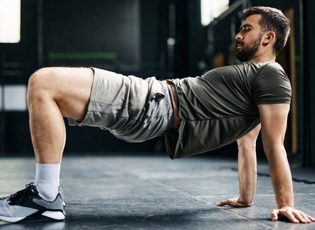 man performing reverse plank bridge part of bodyweight workout