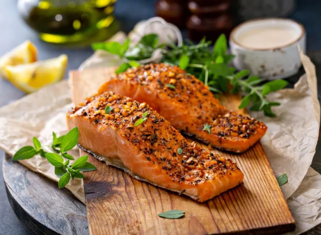 pieces of seasoned salmon on cutting board, protein foods for weight loss concept