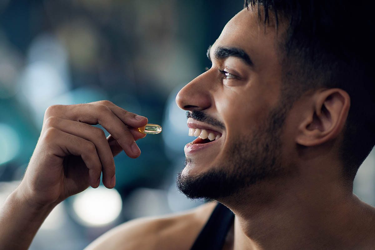 Portrait,Of,Happy,Sportive,Arab,Man,Taking,Supplement,Capsule,,Closeup