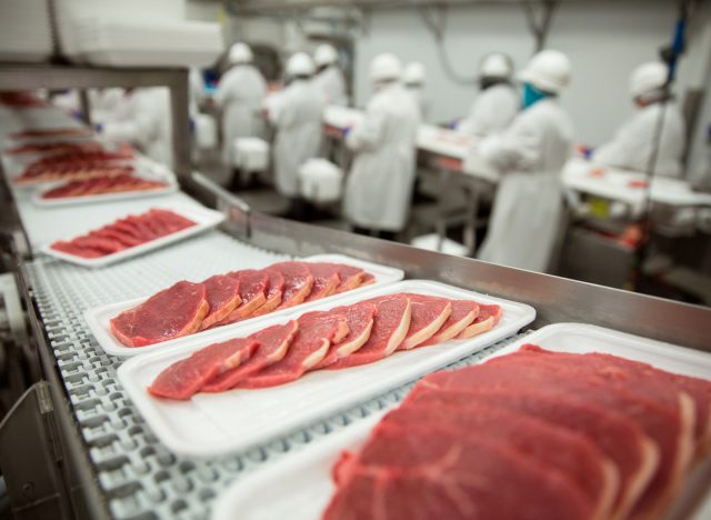 sliced meat on conveyor belt at industrial meat factory