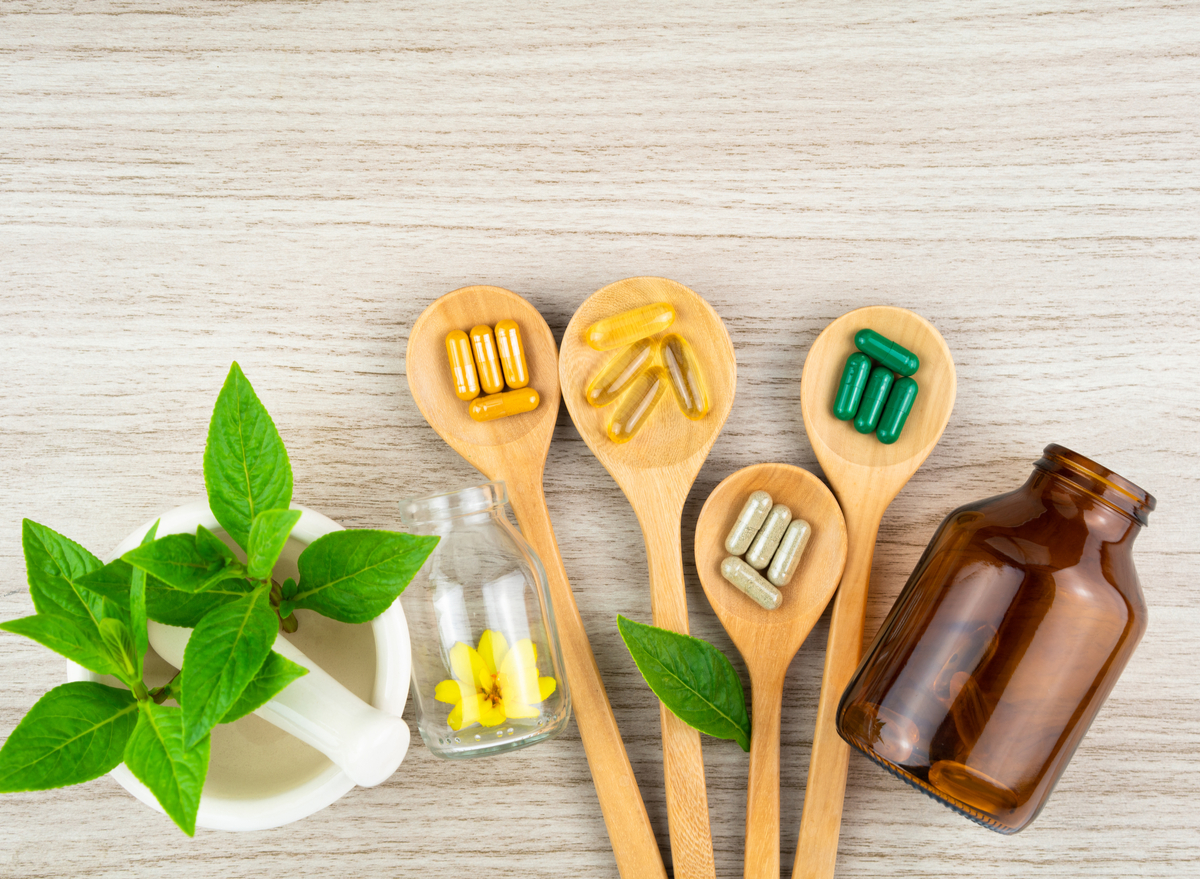 supplements, glass bottle, and leaves