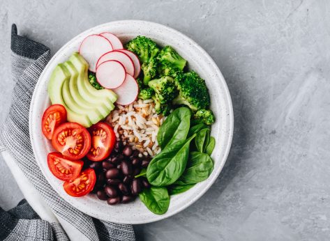 vegan burrito bowl with veggies, avocado, rice, and beans
