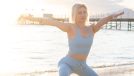 mature woman doing beach yoga and keeping in shape after 40
