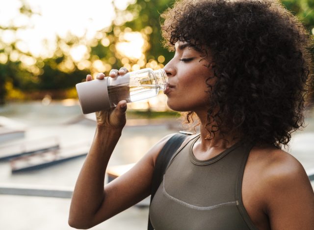 A sports woman drinks too much water